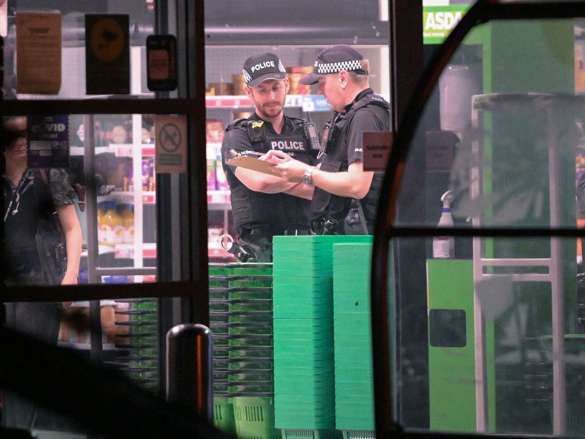 Police officers in Asda, Heath Town, after a man was stabbed. Photo: SnapperSK