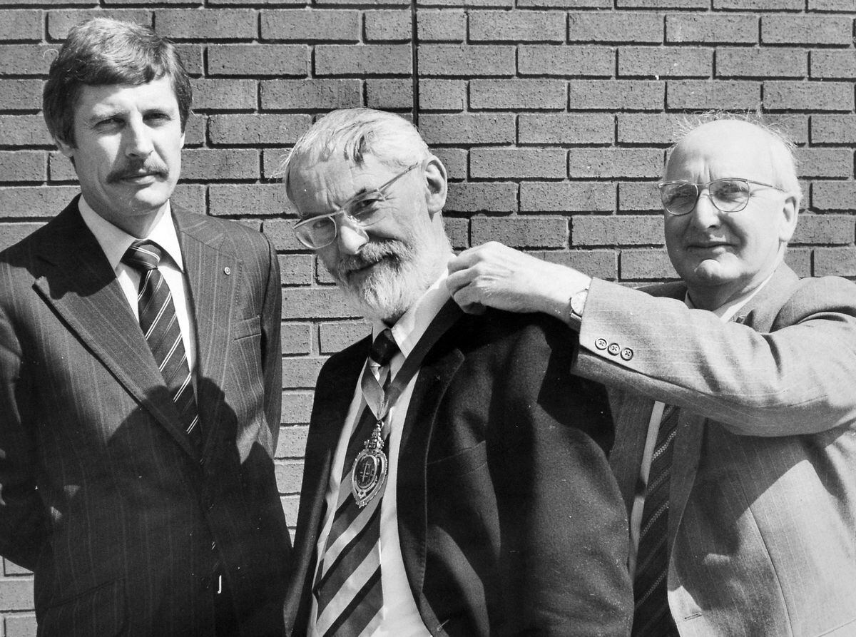 John Lishman receiving his chain of office as new president of Wolverhampton Law Society in 1984 from outgoing president Kenneth Williams, with secretary Michael Kilvert, left, looking on. 