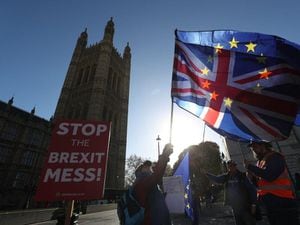Anti-Brexit campaigners wave Union and EU flags outside Parliament