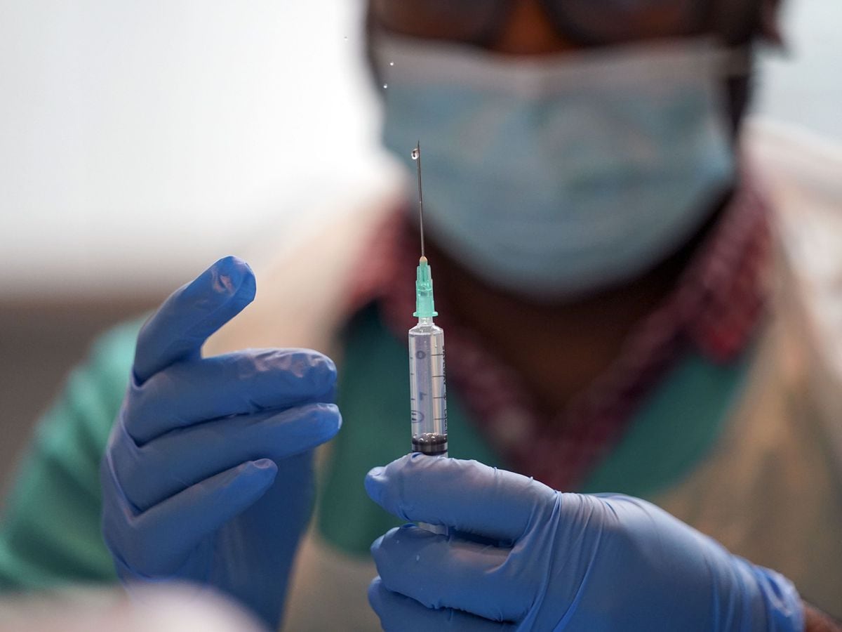 A pharmacist prepares a Covid vaccine