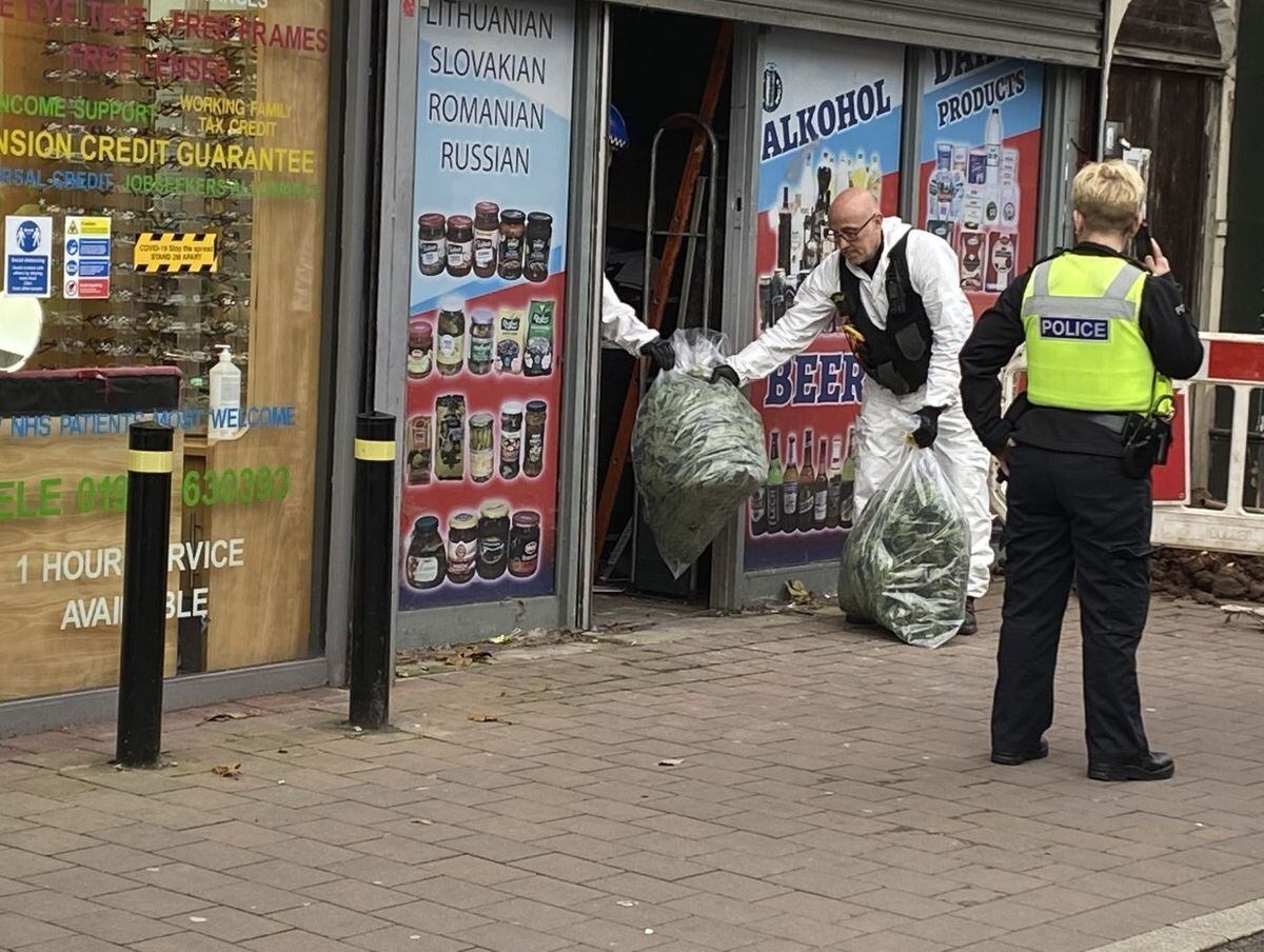 Police were seen removing bags from the shop in Willenhall