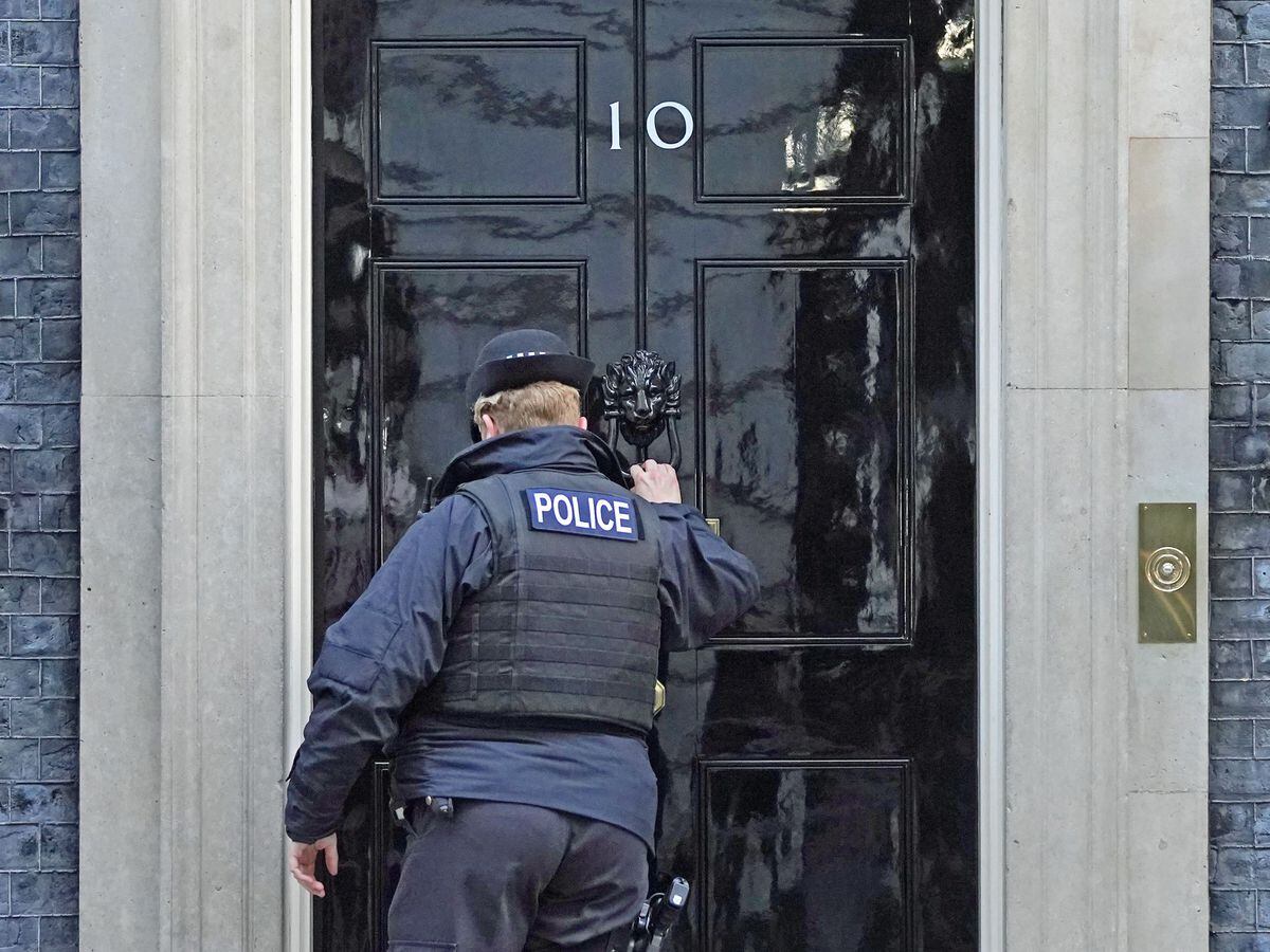 A police officer knocks on the door of the Prime Ministerâs official residence in Downing Street (Stefan Rousseau/PA)