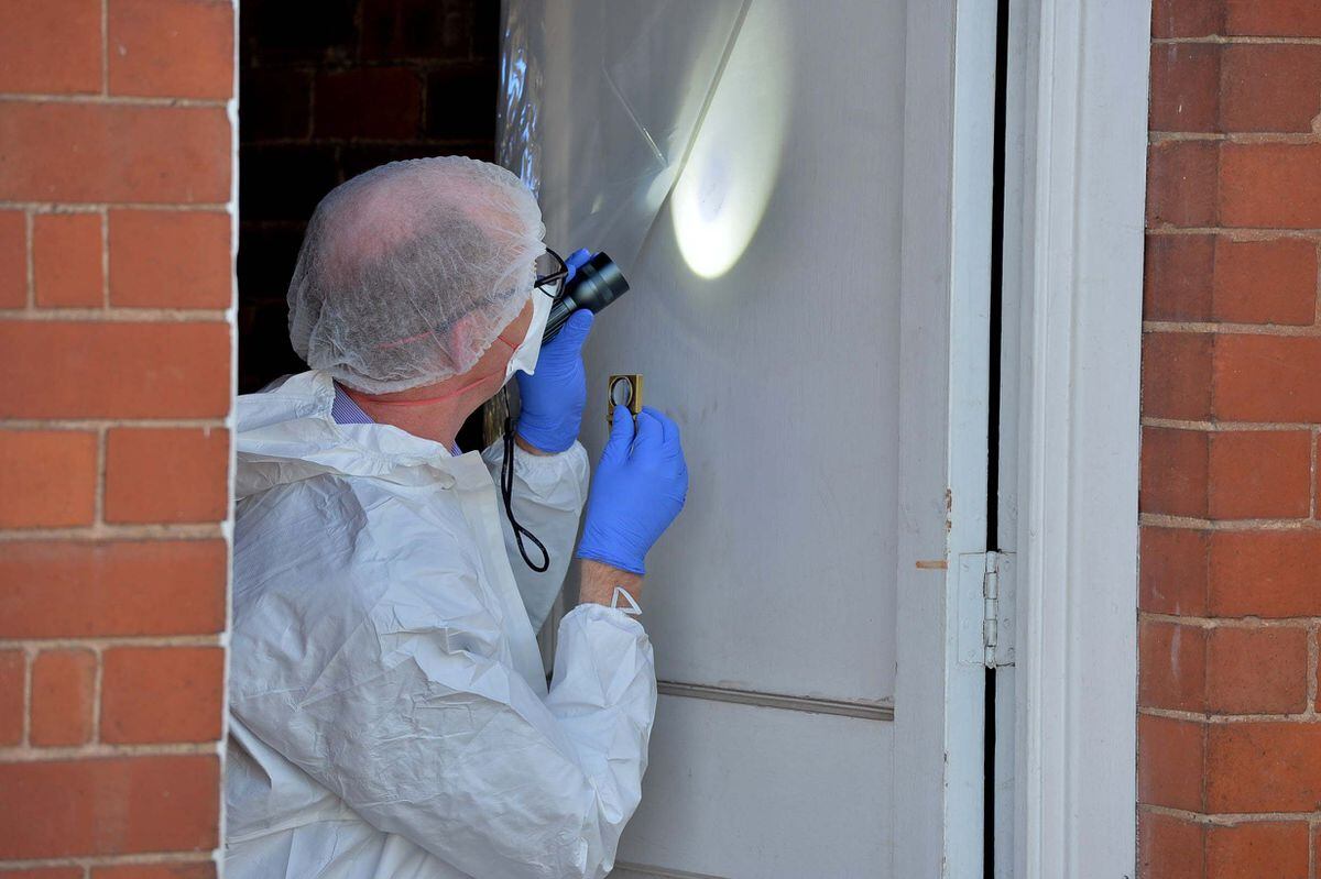 Forensic specialists examine the house