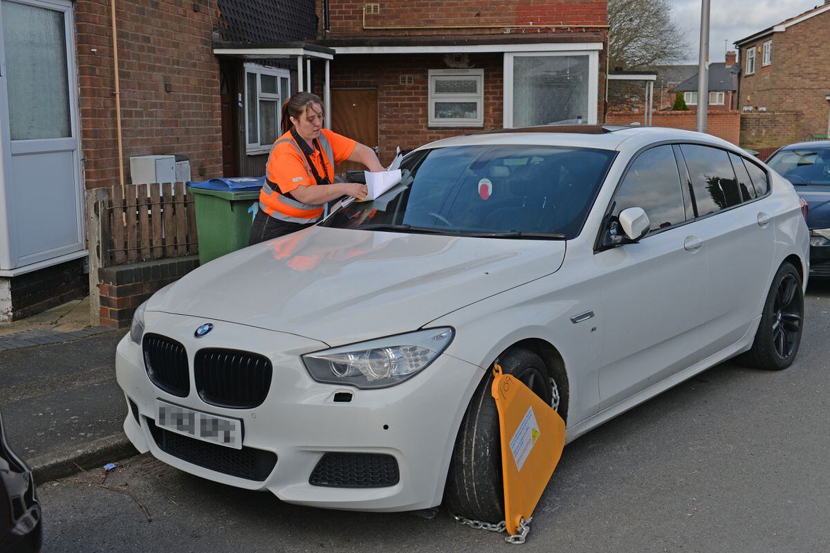 Enforcement officer Jo Halfpenny clamps an untaxed BMW