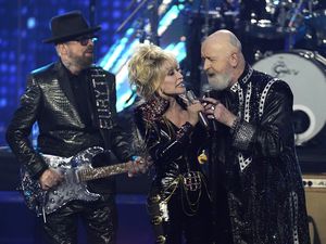Judas Priest’s Rob Halford on stage with Dolly Parton and Dave Stewart at the Rock & Roll Hall of Fame ceremony