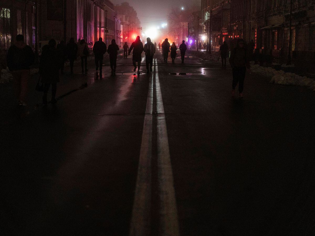 People walk in the city centre, which lost electrical power after yesterday’s Russian rocket attack in Kyiv, Ukraine