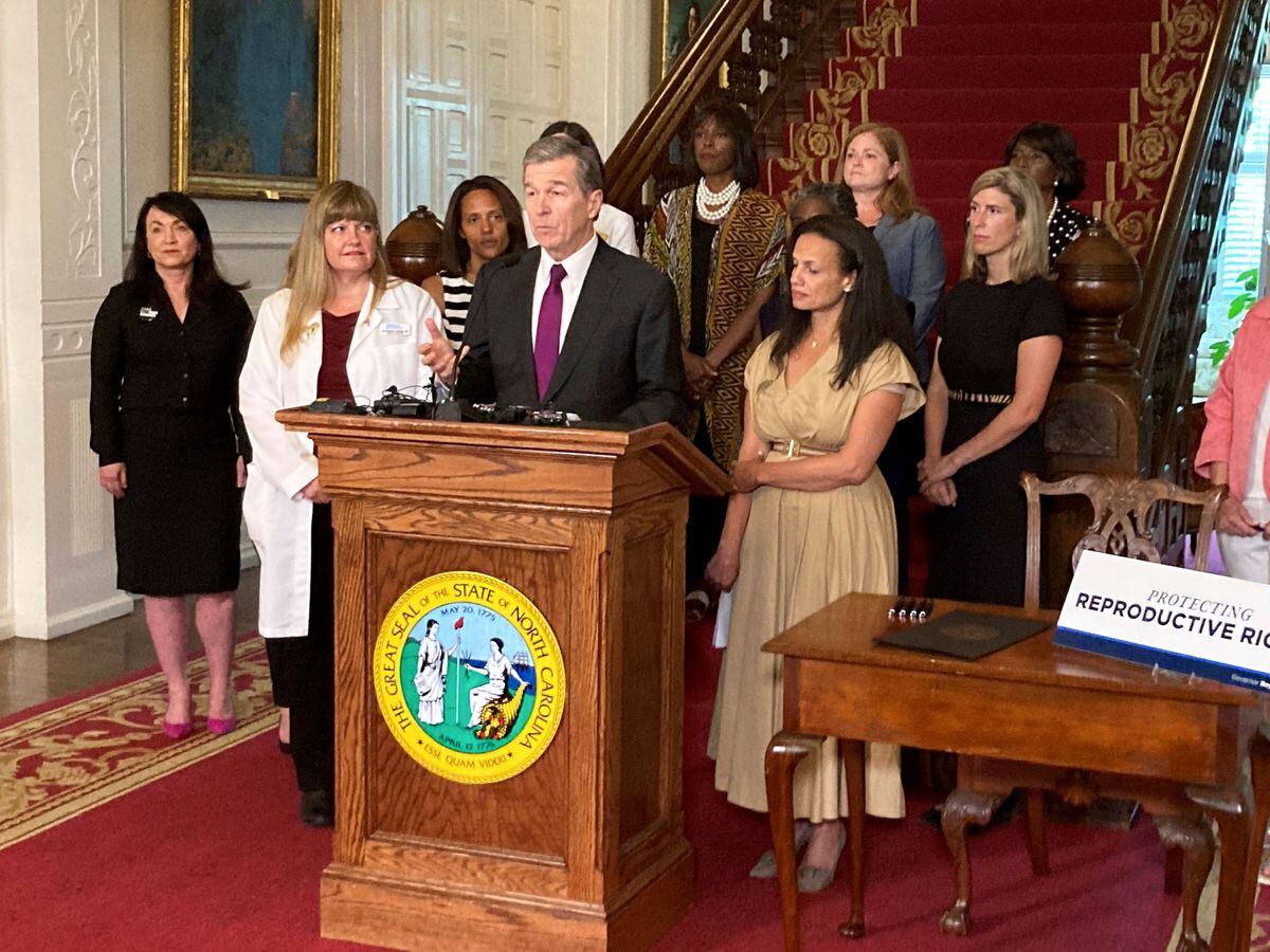 North Carolina Democratic Gov. Roy Cooper speaks at the Executive Mansion in Raleigh, N.C. on Wednesday, July 6, 2022, before signing an executive order designed to protect abortion rights in the state. The order in part prevents the extradition of a woman who receives an abortion in North Carolina but may live in another state where the procedure is barred