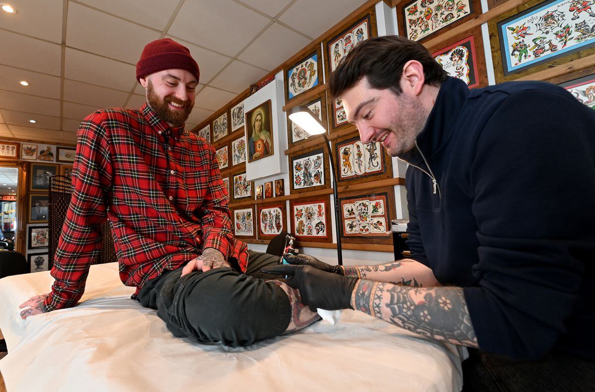 Artist Ben Jeffs gives Mike Hodges a tattoo. 