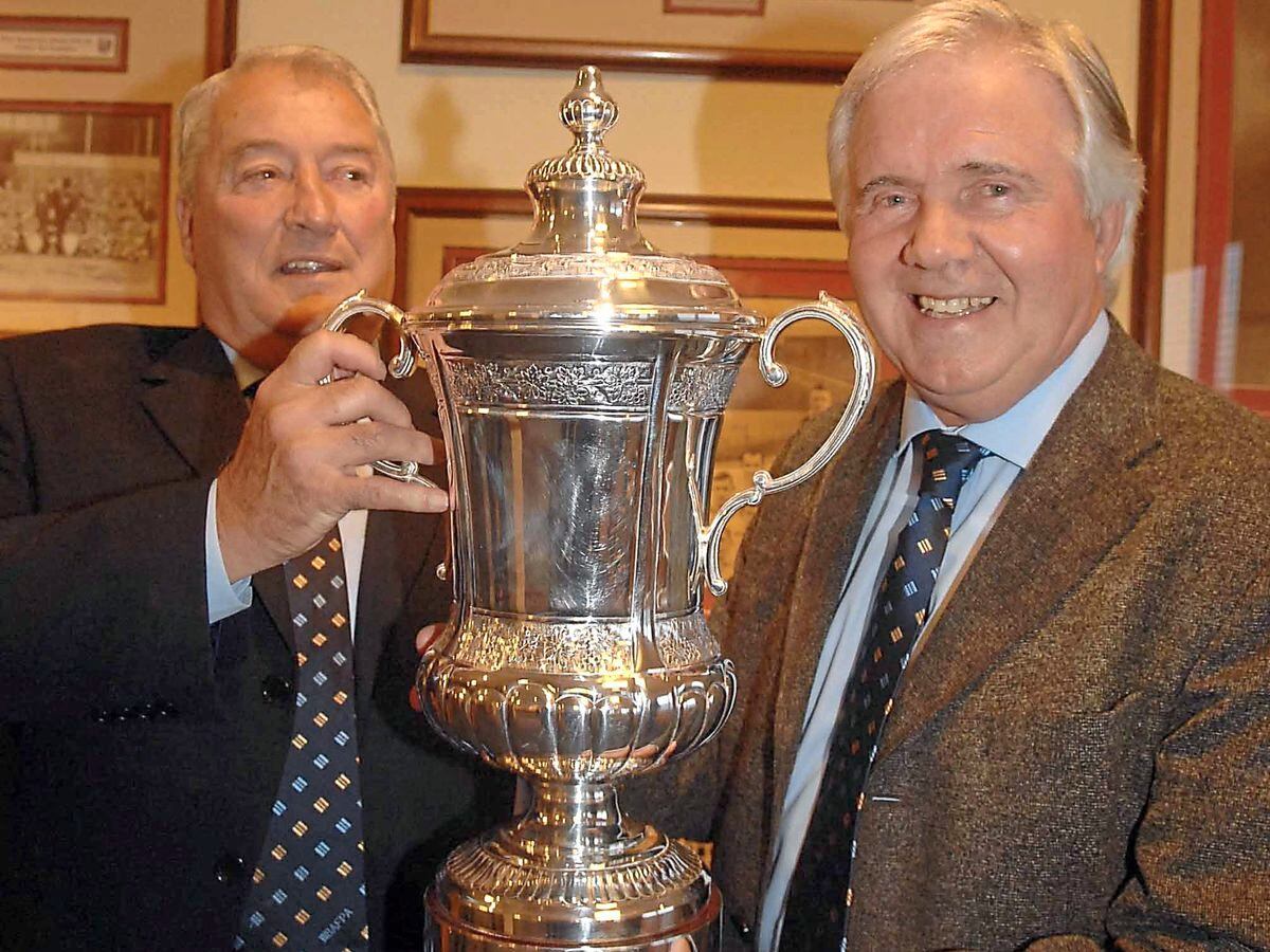With their hands on a replica of the FA Cup again, (left) Graham Williams, and Bobby Hope, attending the 40th reunion dinner, at the Hawthorns.
