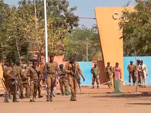 In this image made from video, mutinous Burkina Faso soldiers walk outside the Guillaume Ouedraogo military camp in Ouagadougou