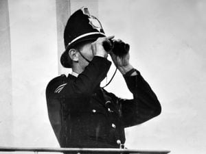 A police officer scans the Molineux crowd.