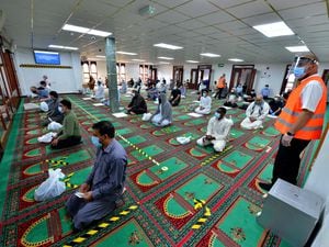 Disposable paper sheets are given to be used by individuals when praying, with clear markings on the floor to ensure social distancing