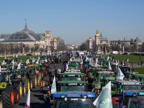 Tractors park in front of the Grand Palais museum, left, in Paris on Wednesday