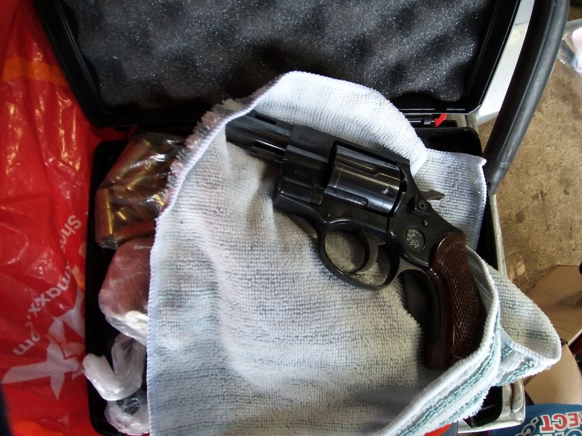 A gun and 97 rounds of ammunition was found