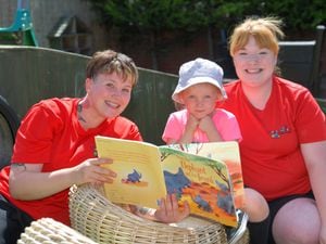 Rebecca Steventon and Alice Holtom read to one of the children at Tiddlywinks Kiddy's Nursery in Tipton