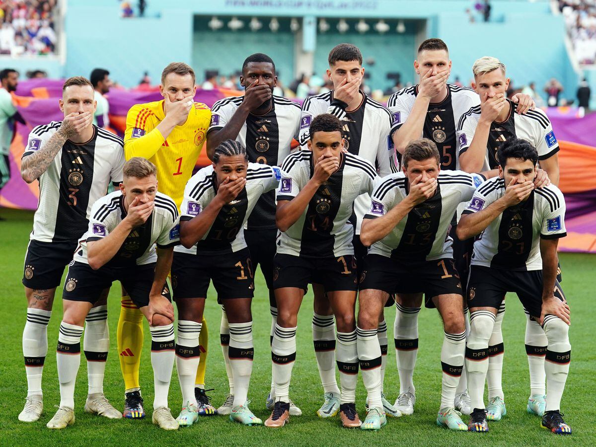 Germany's players cover their mouths in protest at being blocked from wearing the OneLove armband
