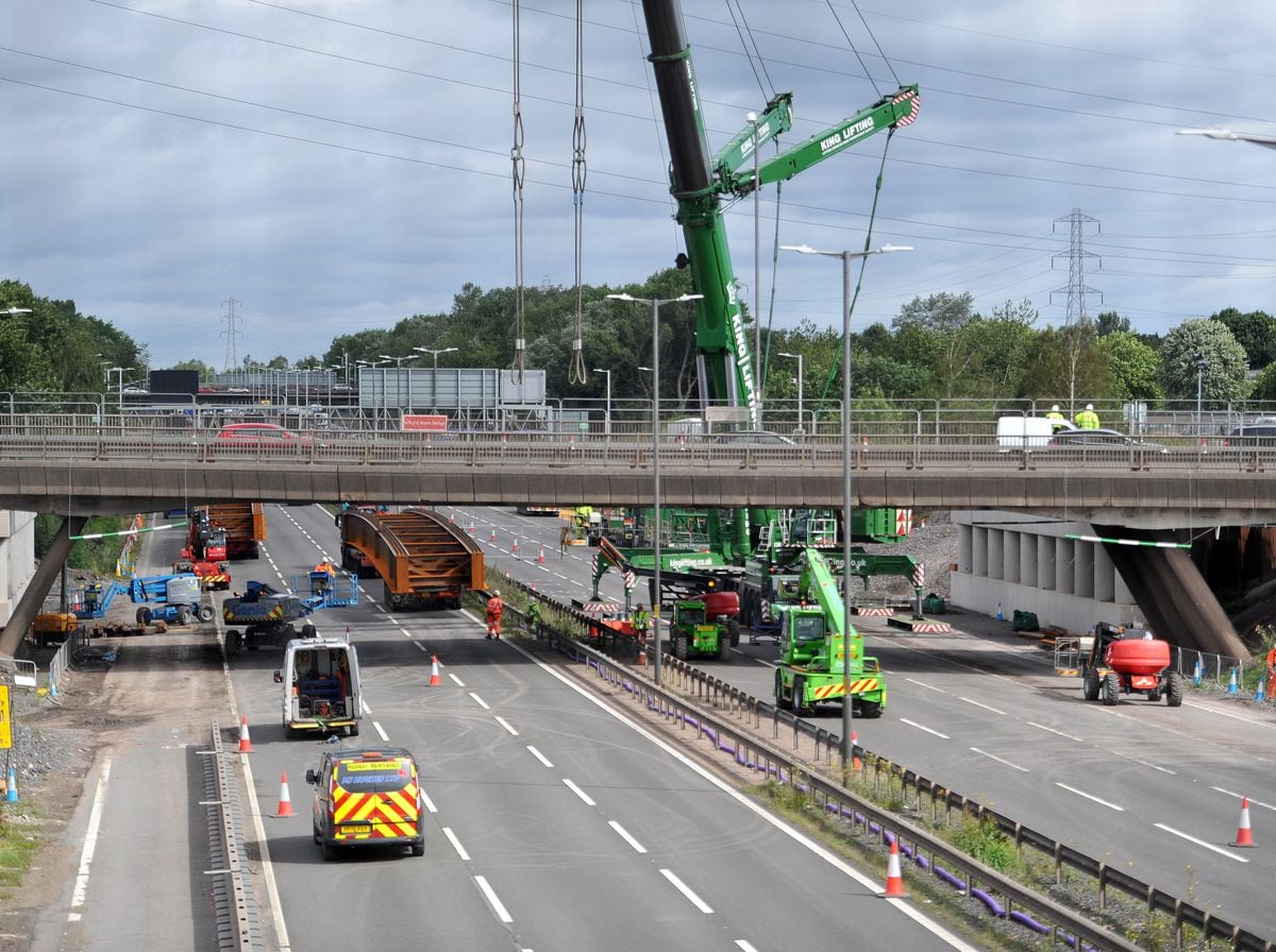 The scene showing the crane and bridge beams at Junction 10 of the M6