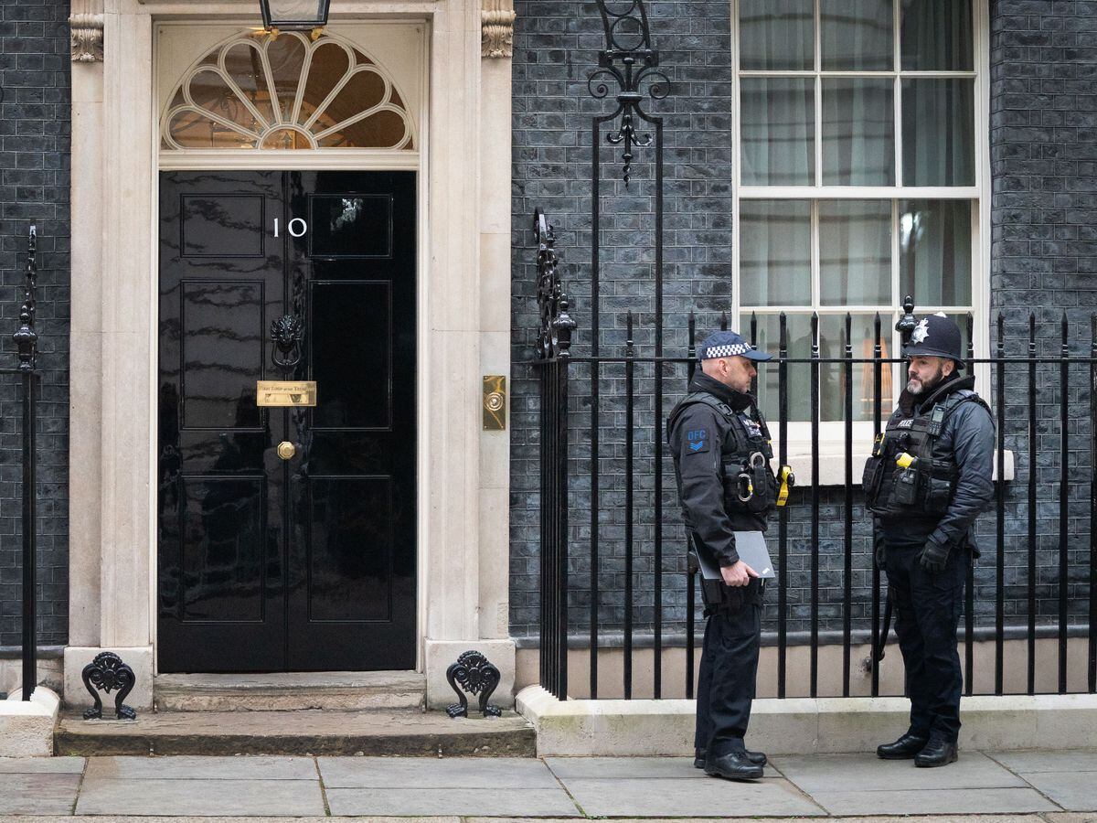 The exterior of No 10 with two policeman