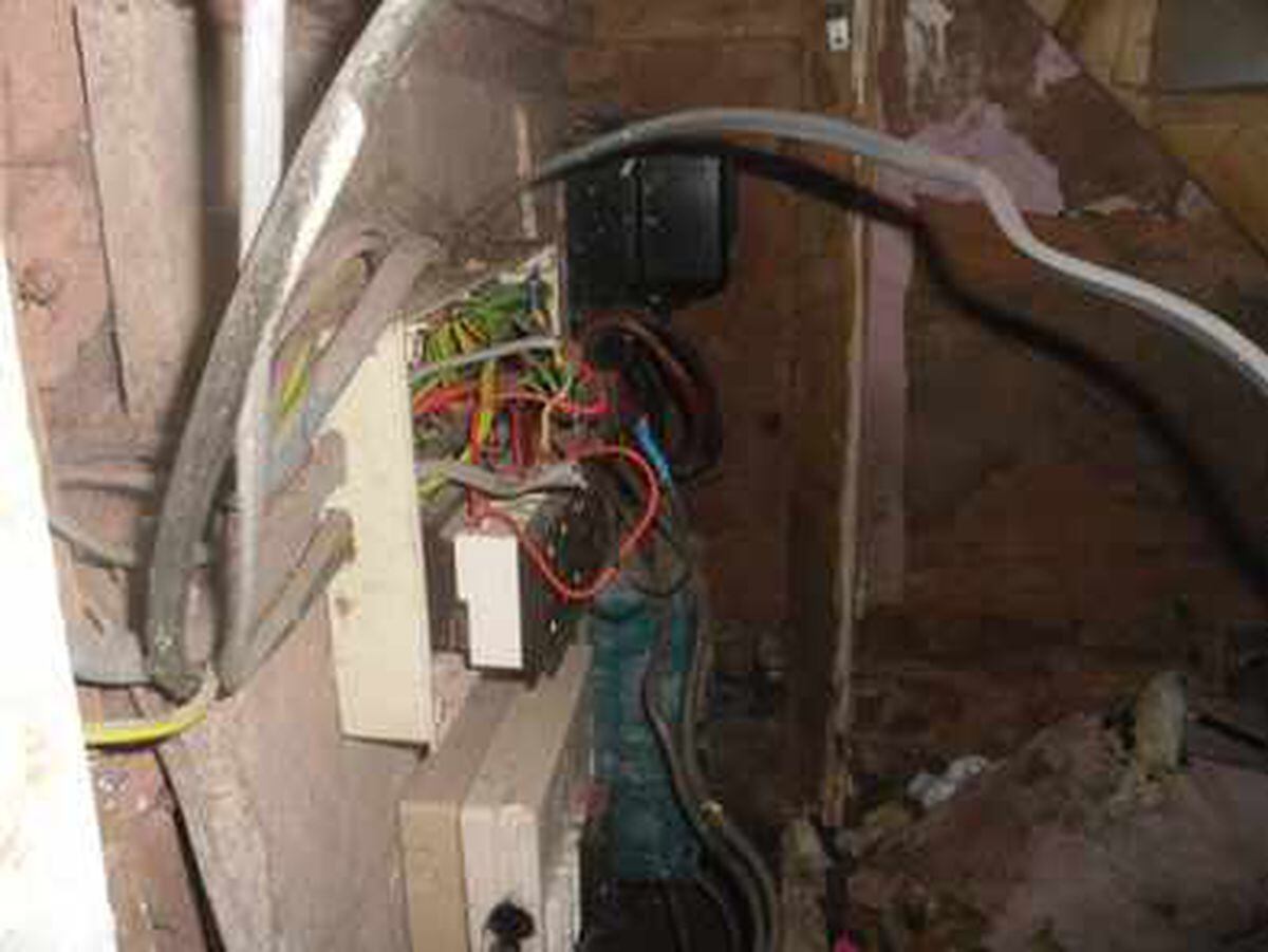 Dangerous electric wiring under stairs of the house in which 40 Romanians - including several young children - were living