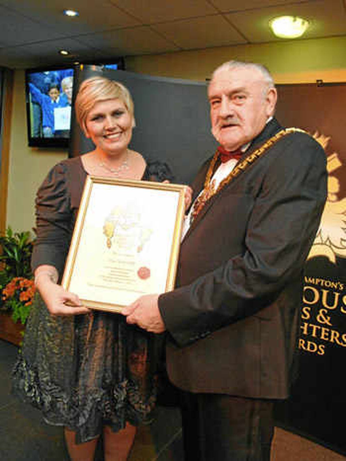 Heroine Lisa Potts is presented with an award by Bert Turner during his time as Mayor