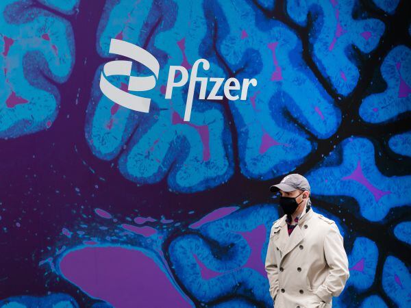 A man walks past Pfizer HQ