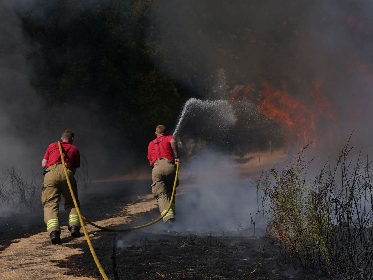Firefighters battle a grass fire on Leyton flats in east London, as a drought has been declared for parts of England following the driest summer for 50 years