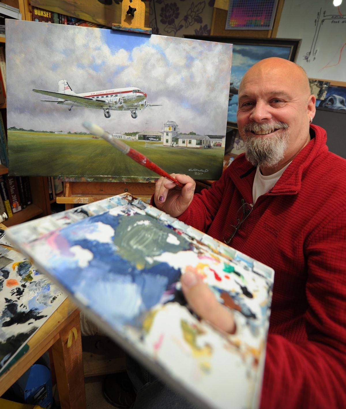 Artist Andy Gould, of Wolverhampton, with his painting of Pendeford Airport in 1958, featuring a Don Everall DC-3.
