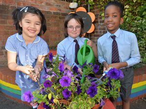 Children at Blue Coat Infant and Junior School, Walsall with the peace garden they have created. Pictured left, Syuzuki Ricketts-Chu, six, Noah Mattews, nine, and Emmanuel Abioden, six