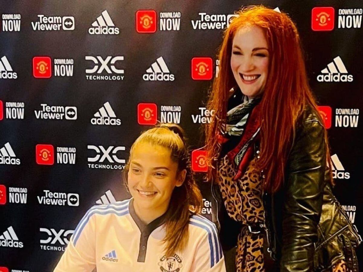 Laura Doyle with Safia Middleton-Patel signing for Manchester United