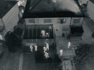 Police released an image of the moment one of the burglary suspects was arrested off a conservatory roof. Photo: @dronesWMP