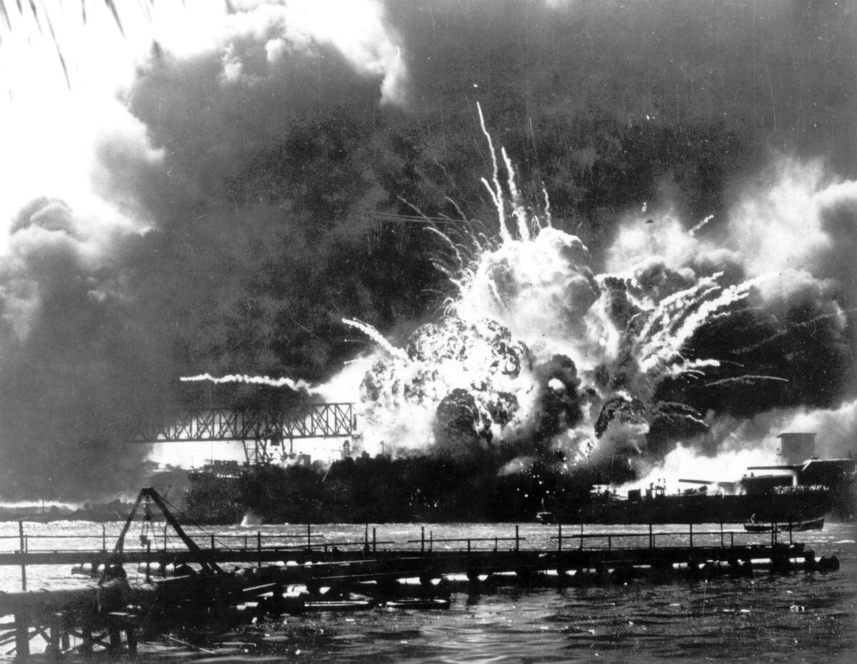 The destroyer USS Shaw explodes after being hit by bombs.
