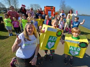 Taking part in a sponsored walk to raise money for a defibrillator, (front) Rachel Dingle, of Burntwood, Sarayah Dingle, aged six, and Bodhi Dingle, aged four, at Chasewater, joined by pupils and parents from Fulfen Primary School.