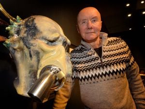 Irvine Welsh poses in front of an artwork by Max Stewart before his big show