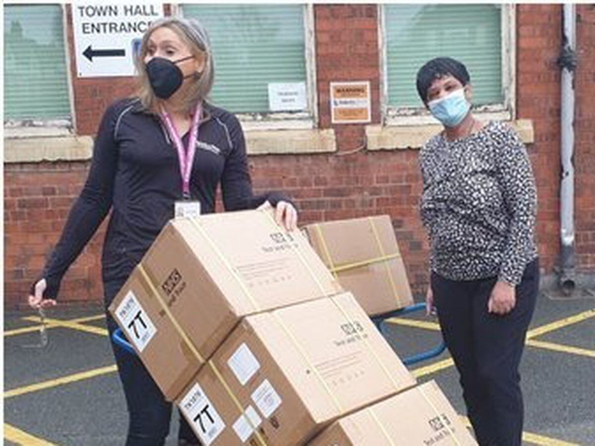 Dr Lisa McNally and a Healthy Sandwell colleague with boxes of unopened Lateral Flow Tests. Photo: Sandwell Council