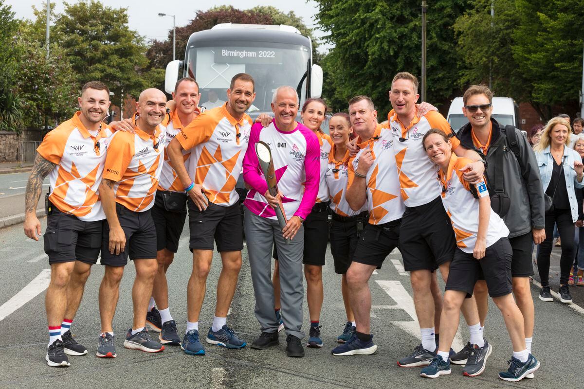 Steve Bull carries the Queens Baton to Molineux with a police escort