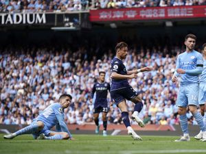 Aston Villa's Matty Cash, center, runs to celebrate after scoring his sides first goal during the English Premier League soccer match between Manchester City and Aston Villa at the Etihad Stadium in Manchester, England, Sunday, May 22, 2022. (AP Photo/Dave Thompson).