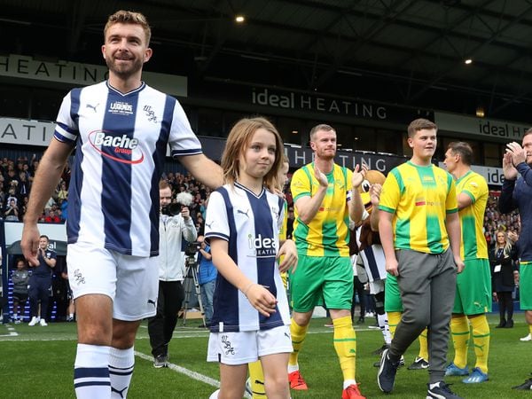 WEST BROMWICH, ENGLAND - SEPTEMBER 24: James Morrison and Chris Brunt along with their children walk out to a guard of honour ahead of the match at The Hawthorns on September 24, 2022 in West Bromwich, England. (Photo by Adam Fradgley/West Bromwich Albion FC via Getty Images).