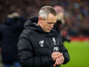 Neil Critchley the head coach / manager of Liverpool U21 checks his watch.