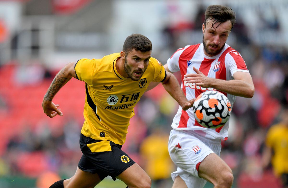 Wolverhampton Wanderers's Patrick Cutrone battles with Stoke City