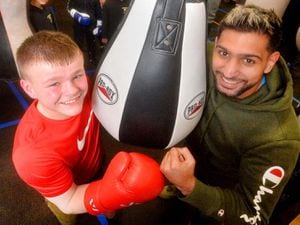Former world champion boxer Amir Khan, front right, with Lleyton Hyde, aged 13, front left, and other boxes and coaches at Willenhall Town Amateur Boxing Club