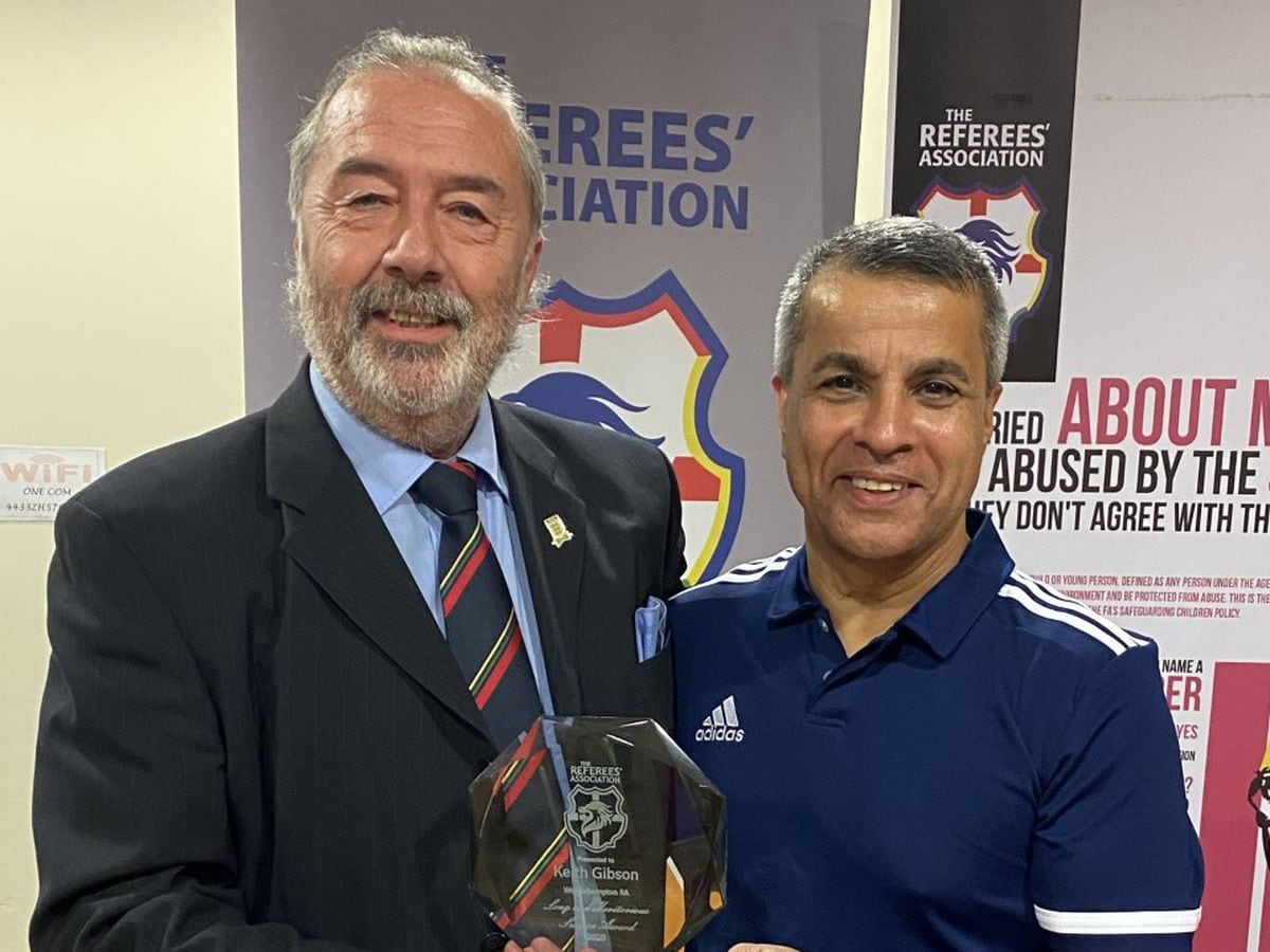 Keith Gibson, left, receives the Long Service & Meritorious Award for from the National Referees’ Association