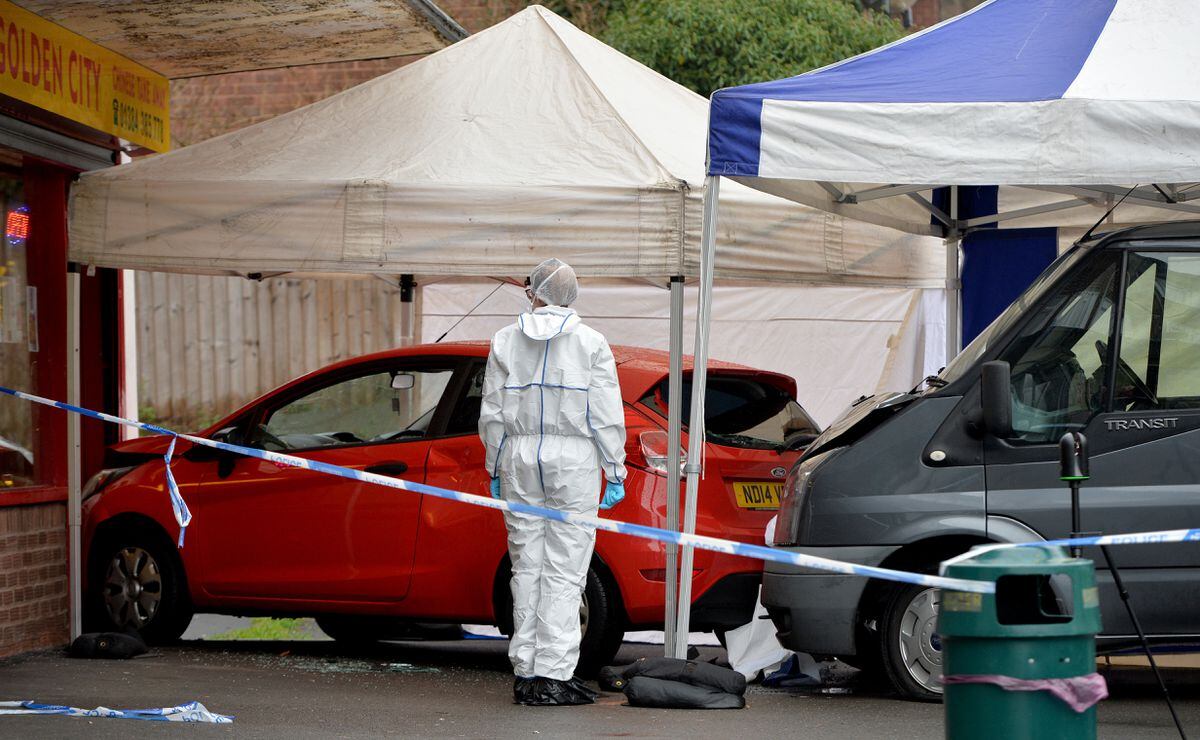 Police forensic teams cordon off the Ford Fiesta in which Morrad and Yasir Hussain had been travelling in and the van which rammed the car 