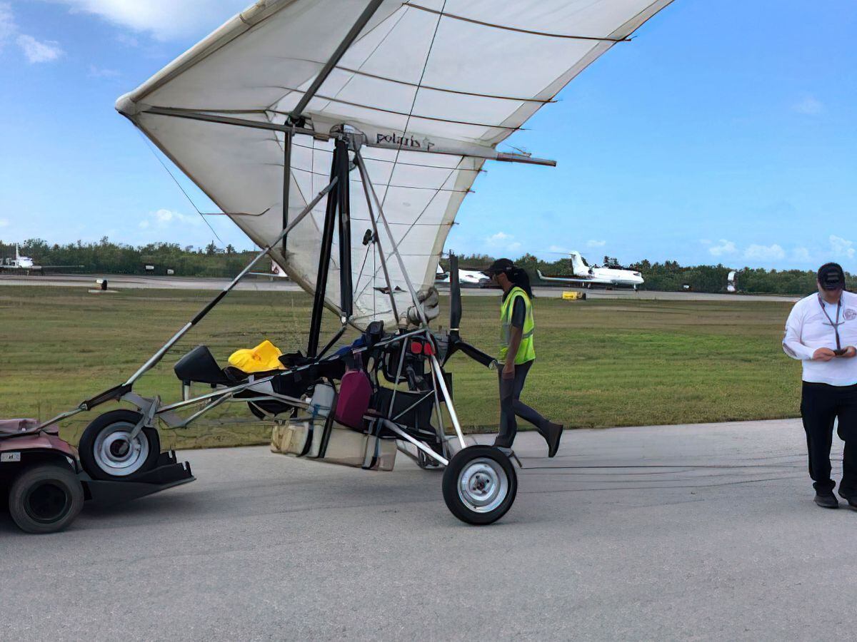 Key West International Airport personnel examine an ultralight aircraft that landed illegally at the airport carrying two Cuban men