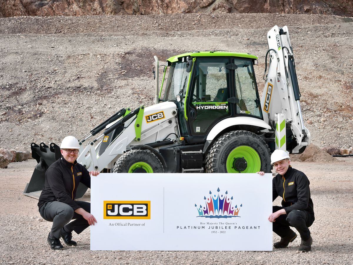 JCB engineering graduate James Ownsworth, left, and engineering degree apprentice Jed Brandreth  with JCB’s hydrogen powered backhoe loader which will take part in the Platinum Jubilee Pageant 