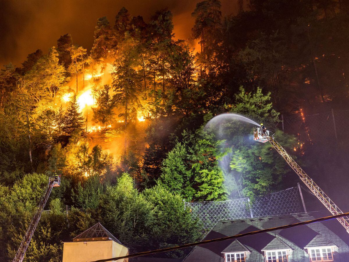 Firefighters tackle a fire in the Ceske Svycarsko (Czech Switzerland) National Park, above the village of Hrensko, Czech Republic