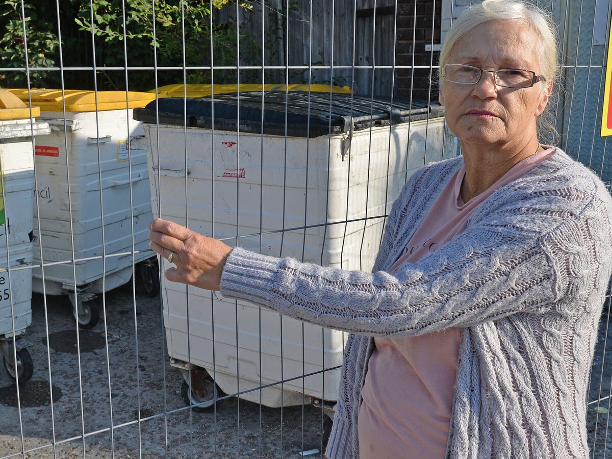 Carol Faulkner shows the bins at derelict garages in New Invention Square, Lichfield Road, Willenhall
