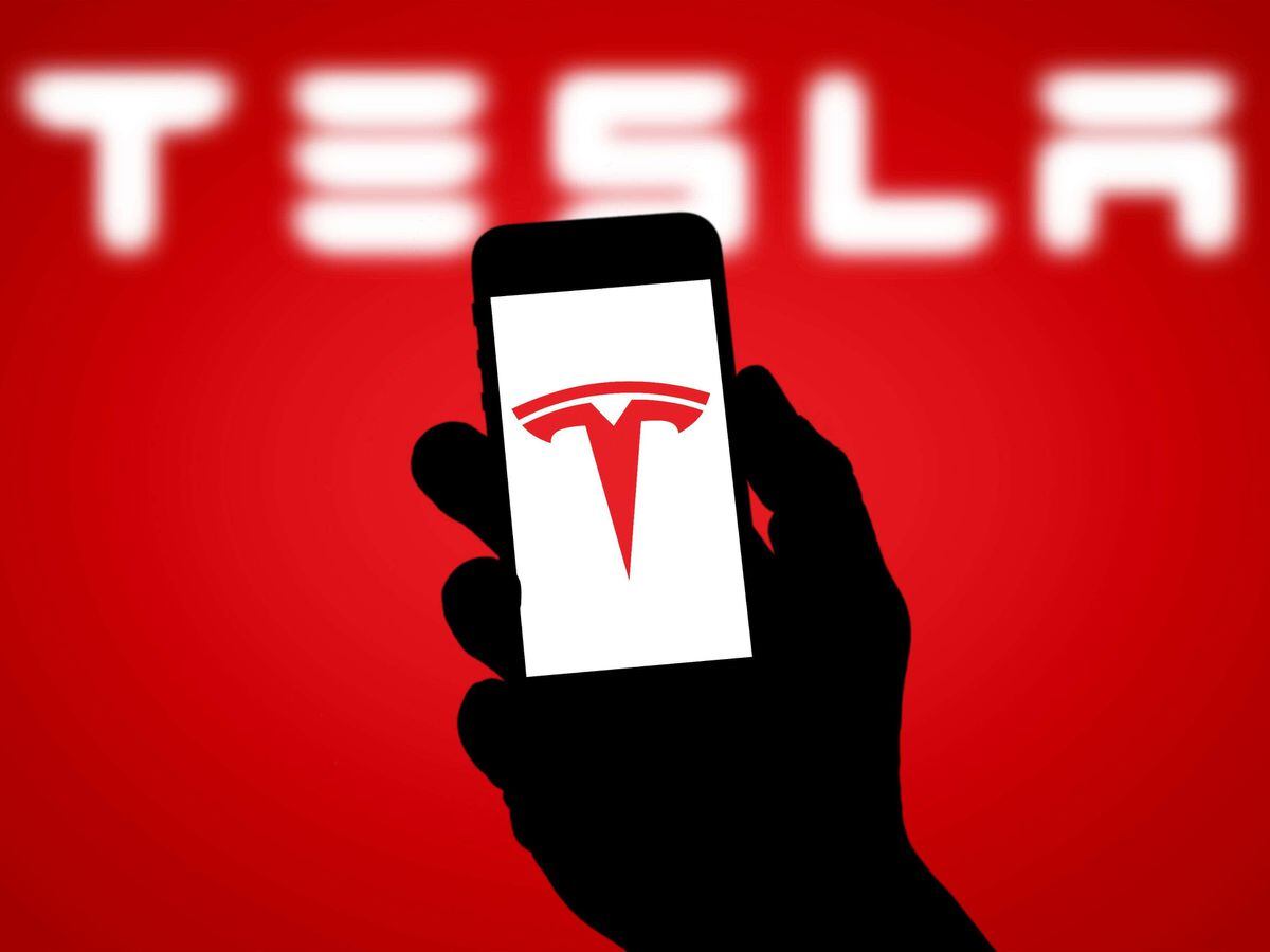 A Tesla logo on a phone