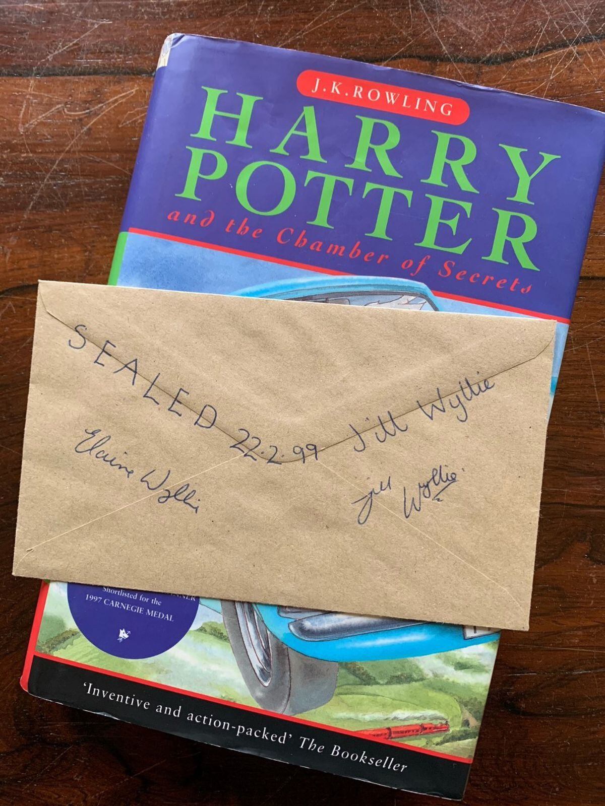 A signed copy of Chamber of Secrets and envelope relating to a meeting with JK Rowling in Dunblane, Scotland in 1999. Photo Hansons