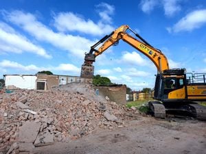 A bulldozer demolishes the former Northicote School site on Northwood Park Road in Bushbury, Wolverhampton