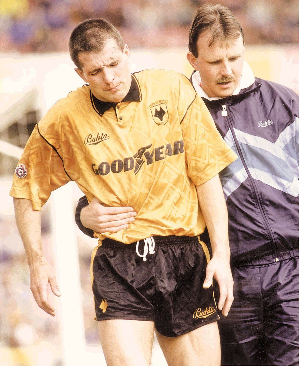 Steve Bull is helped off the pitch by Paul Darby in the 1991/92 season